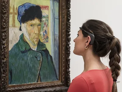 A museum visitor wears the new headset, which collects brainwave data that is used to create real-time images visualizing their response to art.